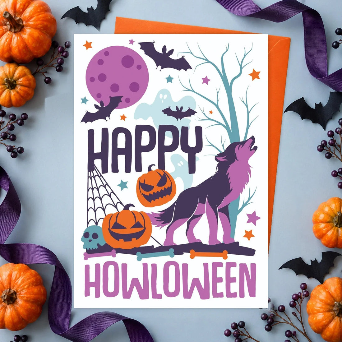 Happy Howloween – Edible Dog Halloween Card, chicken flavour by Scoff Paper, shown with an orange envelope