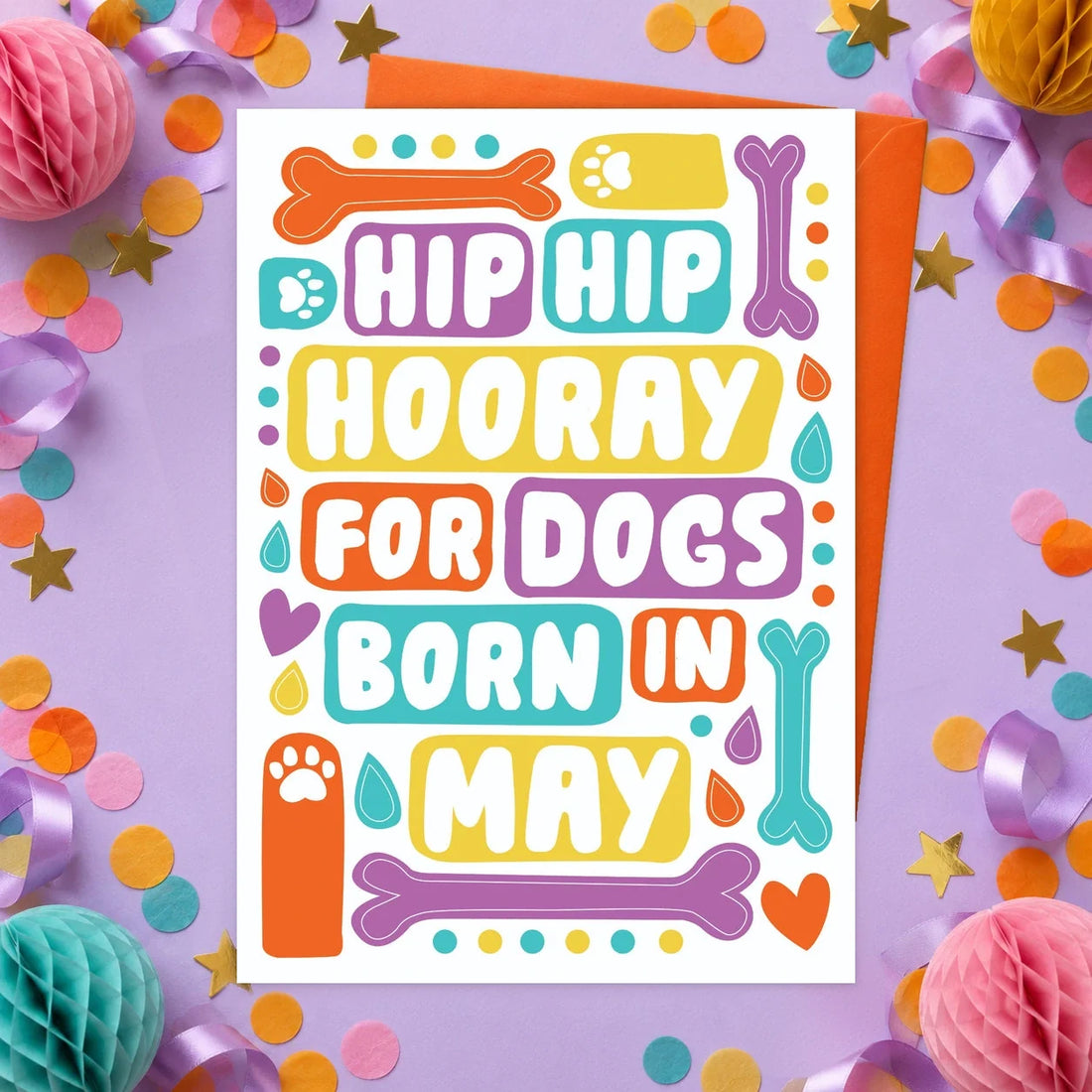 May Birthday – Edible Dog Birthday Card, bacon flavour by Scoff Paper, shown with an orange envelope