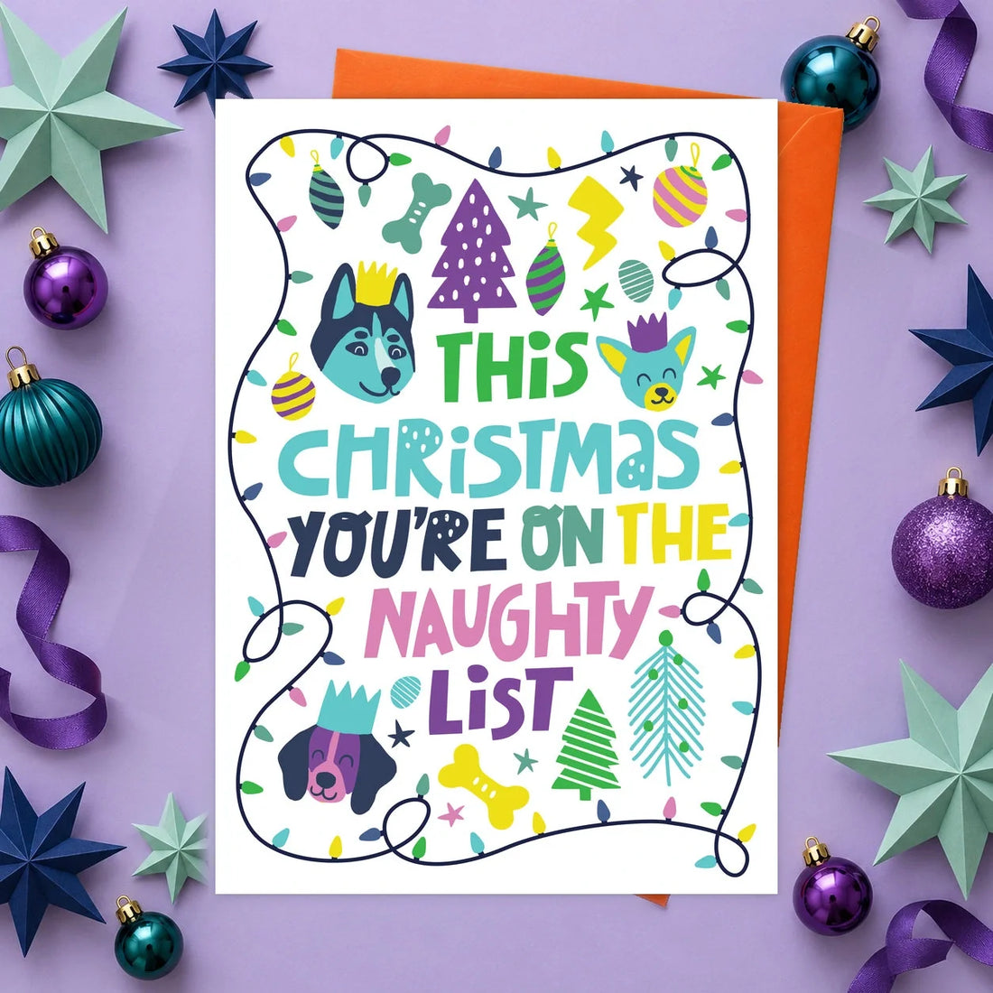 Naughty List Christmas – Edible Dog Christmas Card, chicken flavour by Scoff Paper, shown with an orange envelope