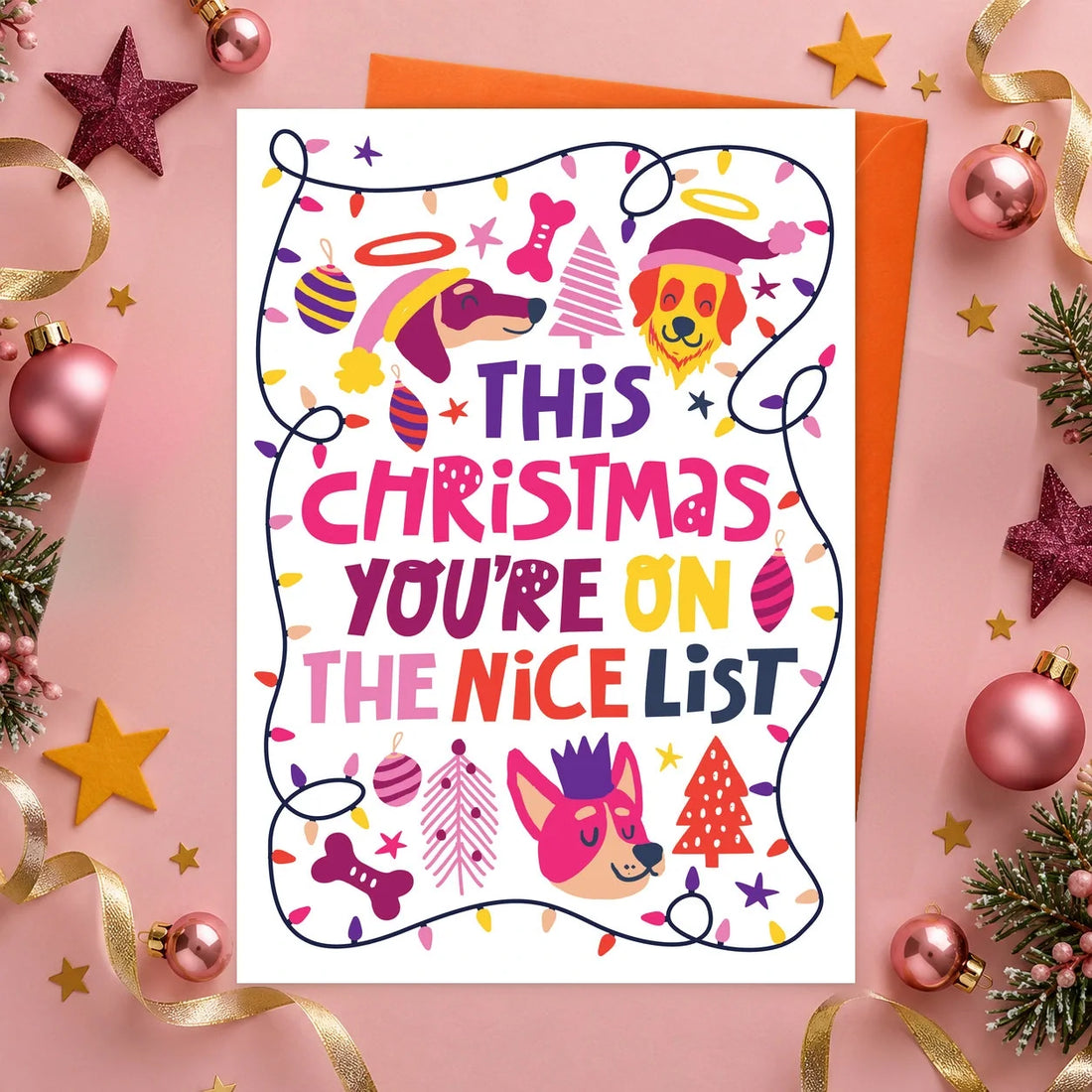 Nice List Christmas – Edible Dog Christmas Card, chicken flavour by Scoff Paper, shown with an orange envelope
