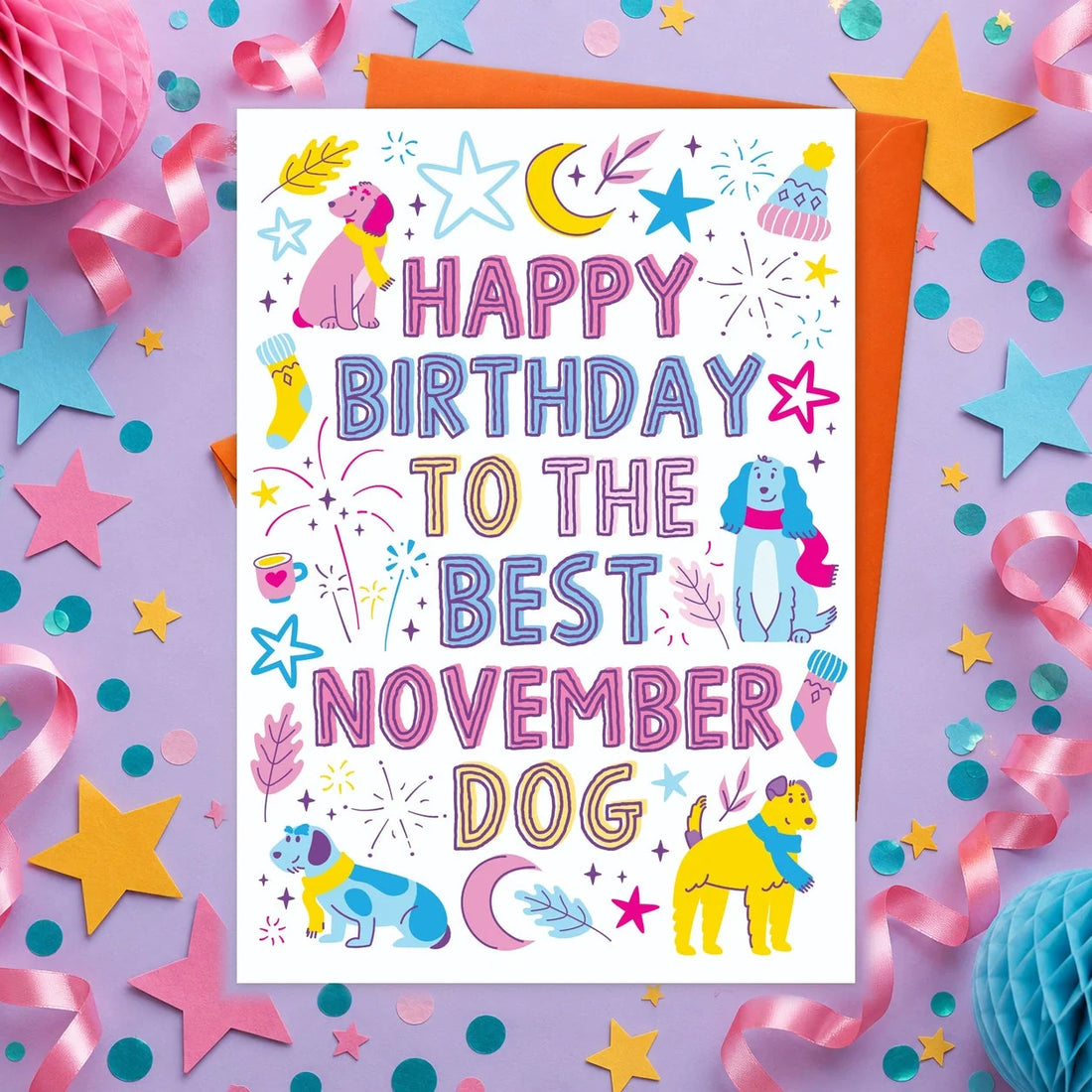 November Birthday – Edible Dog Birthday Card, bacon flavour by Scoff Paper, shown with an orange envelope